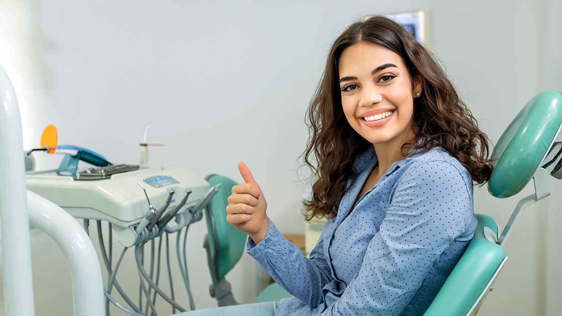 lady with a thumbs up smiling